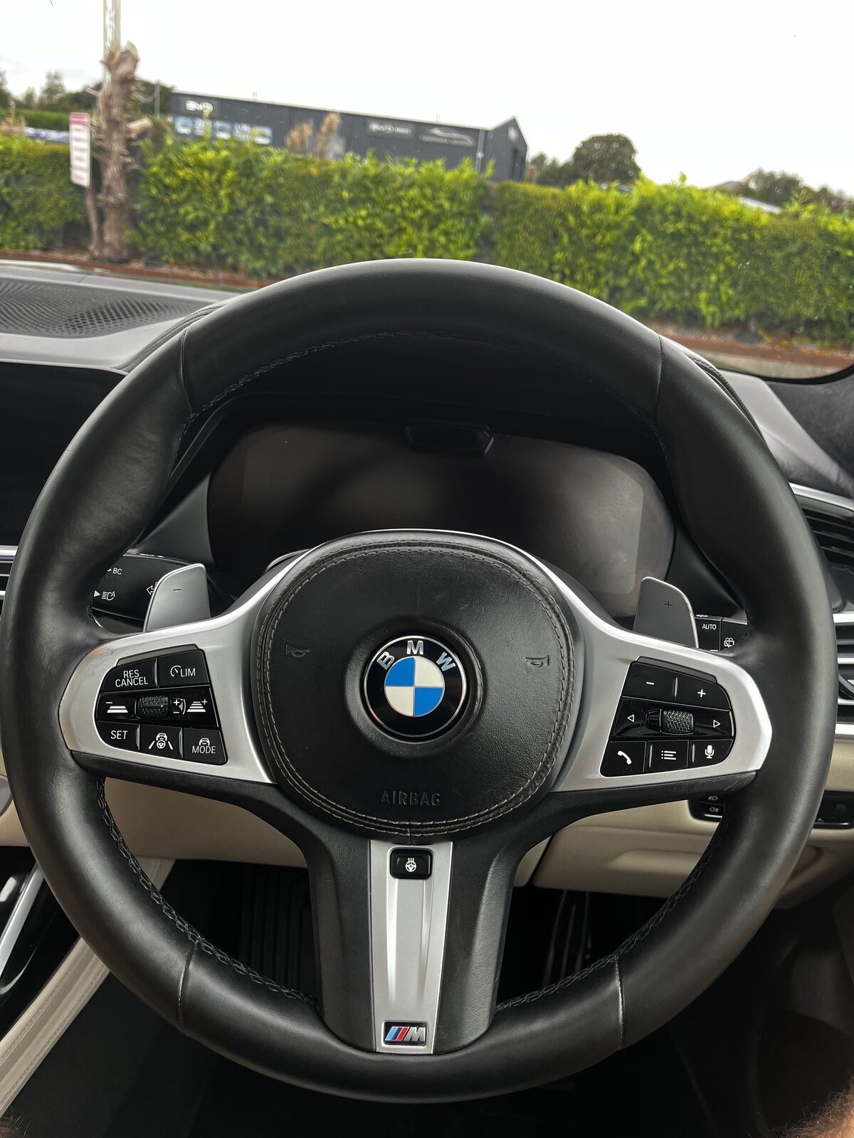 Restored black leather BMW M Sport steering wheel after refinishing by PJ Leather Paint