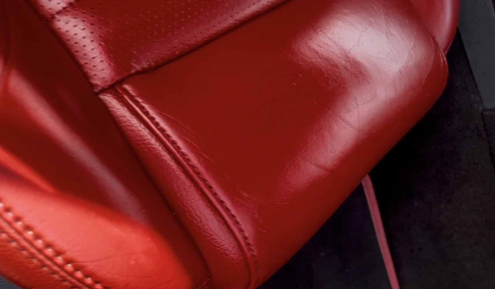 Restored red leather car seat bolster after repair and recolouring by PJ Leather Paint